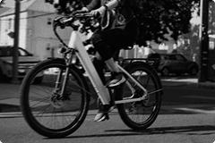 Rider on a white e-bike on a city street