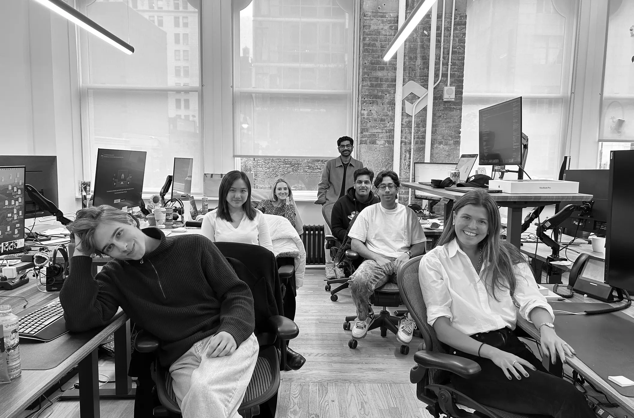 Profound teammates gathered at their desks in the office